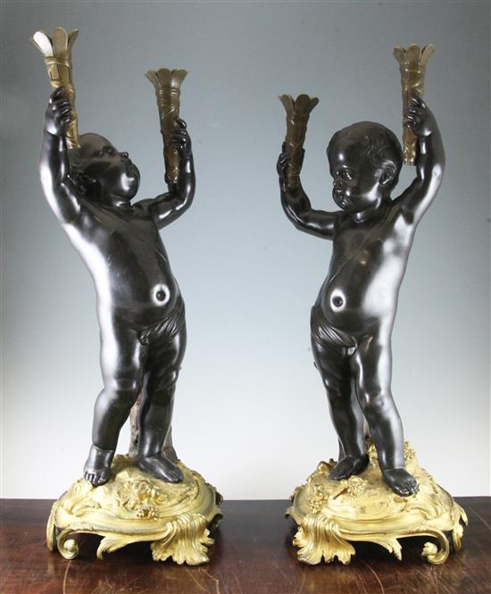 A pair of late 19th / early 20th century French bronze and ormolu torcheres, 28.75in.